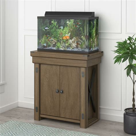 Wayfair aquarium stand - The Larrison Aquarium or Terrarium stand delivers classic style while supporting your 55-gallon fish tank. It's made from wood with a rustic neutral finish, and it has a rectangular silhouette. This piece includes two double-door cabinets with interior storage shelves, ideal for tucking away food, nets, cleaning supplies, and more. It's decorated with black metal hardware and barn-inspired, X ...